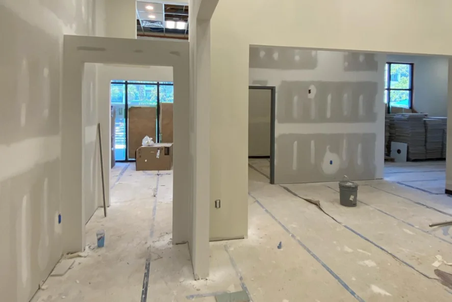 Commercial interior with patched and taped drywall walls and doorways